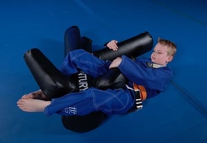 A child practices Brazilian jiu-jitsu on a Versys V.SPAR.2. 