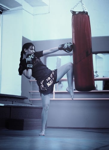 Woman muay thai heavy hanging bag