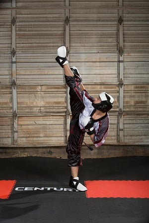 A member of Team Paul Mitchell Karate's point fighting team practices a high kick. Century C-Gear Uniform; Century C-Gear Sparring Gear.