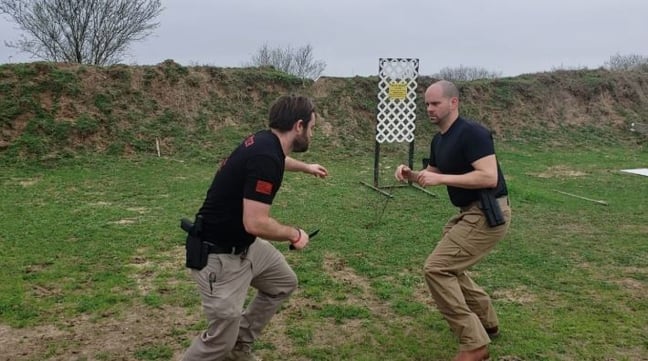 William Tresten and a partner training a close-quarters knife self-defense drill.