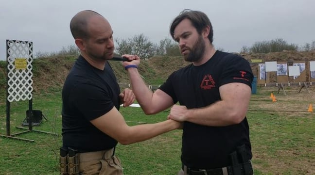 William Tresten and a partner training a close-quarters knife self-defense drill.