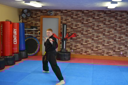 Alec Brown practicing a traditional bo form. Wavemaster Training Bags in the background.