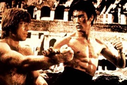 A young Bruce Lee and Chuck Norris fight in one of Lee's films.