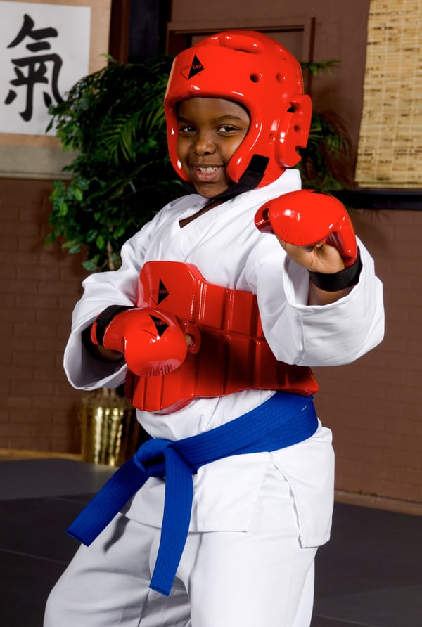A student wearing Century Sparring Gear smiles, showing confidence.