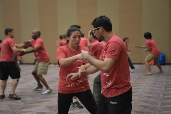 Two attendees at the 2017 Martial Arts SuperShow practice an unarmed kali drill.