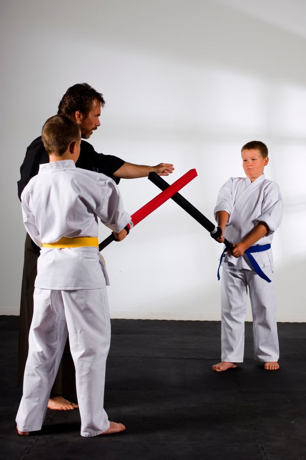 Youth practice sparring with foam katana under the instruction of Shihan Dana Abbott.