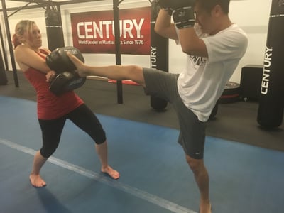 Kicking on a Thai pad. Okay, so this pic is staged, but I really CAN hold for much larger people. Trust me.